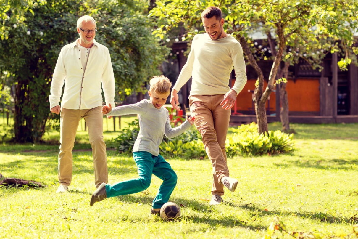 A family playing football outdoors.