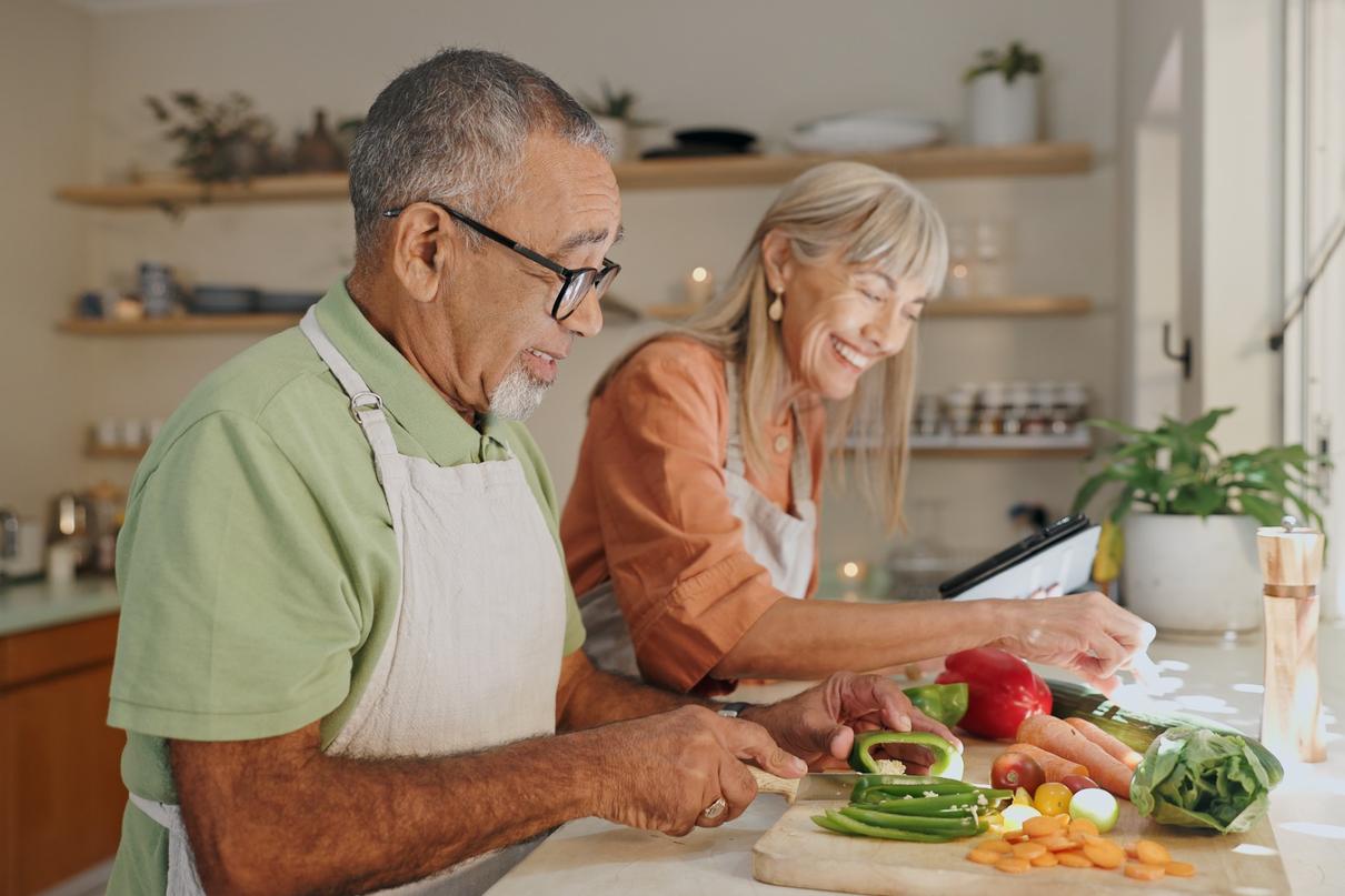 A couple cooking a meal together.