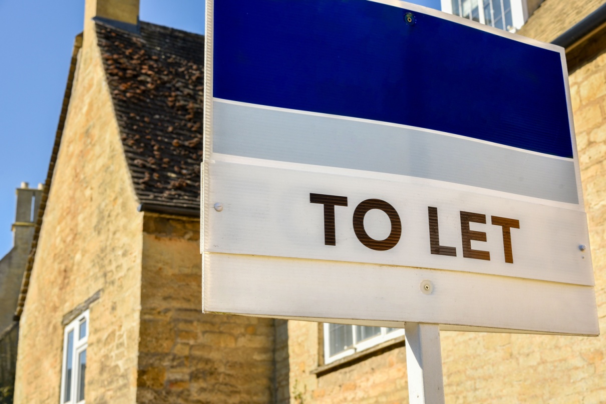 A “to let” sign outside of a home.