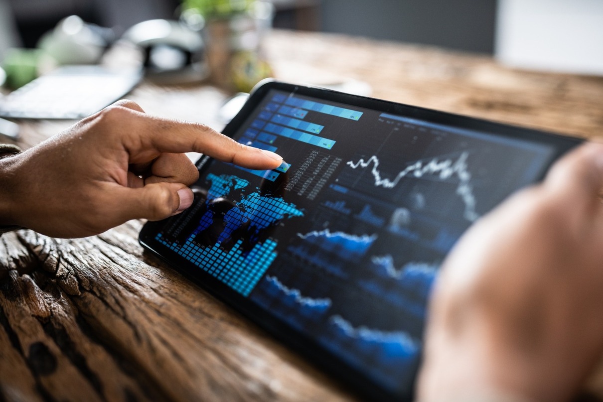 A person reviewing investment performance on a tablet.